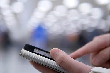 Employee using phone in retail store